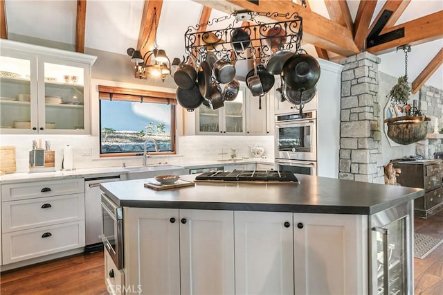 923 Lake Edge Way, Lake Arrowhead, CA 92352 - kitchen featuring stainless steel appliances, a sink, tasteful backsplash, dark wood-style flooring, and a center island