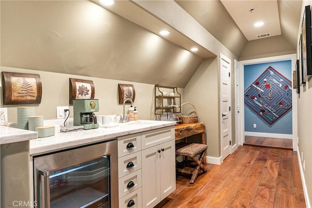 923 Lake Edge Way, Lake Arrowhead, CA 92352 - bar featuring wine cooler, a sink, lofted ceiling, light wood-style floors, and baseboards