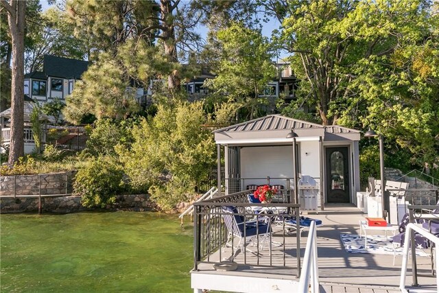 923 Lake Edge Way, Lake Arrowhead, CA 92352 - view of yard with a deck with water view and an outdoor structure