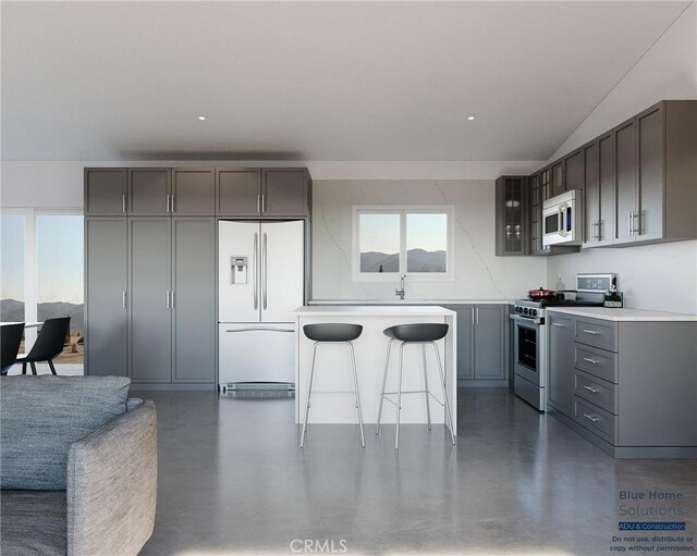 11725 Lagartijo Dr, Apple Valley, CA 92308 - kitchen featuring white appliances, finished concrete floors, gray cabinets, light countertops, and vaulted ceiling