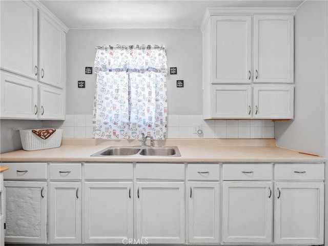 1040 Flora St, Barstow, CA 92311 - kitchen with a sink, white cabinets, light countertops, and tasteful backsplash