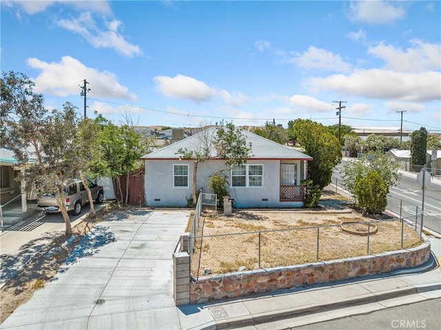 1040 Flora St, Barstow, CA 92311 - ranch-style home with stucco siding, a fenced front yard, and driveway
