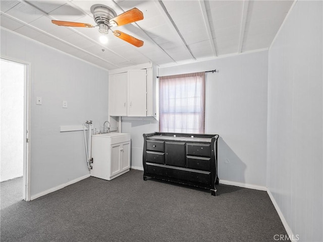 1040 Flora St, Barstow, CA 92311 - washroom with a ceiling fan, dark carpet, and baseboards