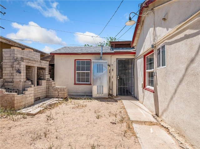 1040 Flora St, Barstow, CA 92311 - property entrance featuring stucco siding and roof with shingles