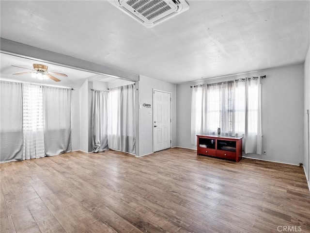 1040 Flora St, Barstow, CA 92311 - unfurnished living room featuring wood finished floors and ceiling fan