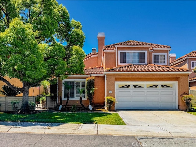 14650 Via Pointe Del Sol, Whittier, CA 90604 - view of front facade with driveway, a chimney, a tiled roof, stucco siding, and a garage