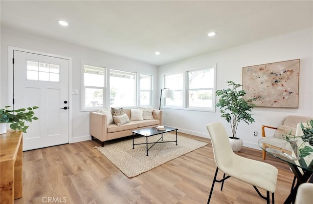 16417 Ivy Ave, Fontana, CA 92335 - living area featuring baseboards, light wood-style floors, and recessed lighting
