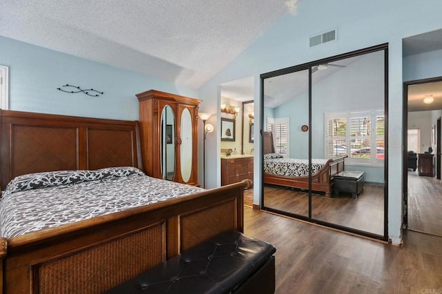 6919 Sandleford Way, San Diego, CA 92139 - bedroom with lofted ceiling, dark wood finished floors, a textured ceiling, and connected bathroom