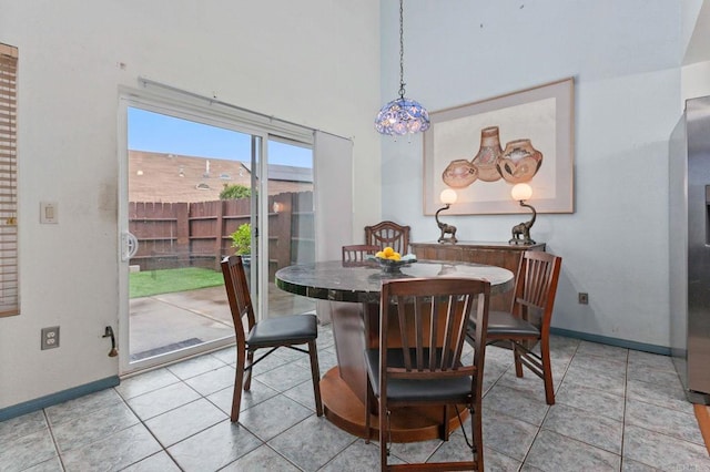 6919 Sandleford Way, San Diego, CA 92139 - dining space featuring baseboards, light tile patterned floors, and a high ceiling