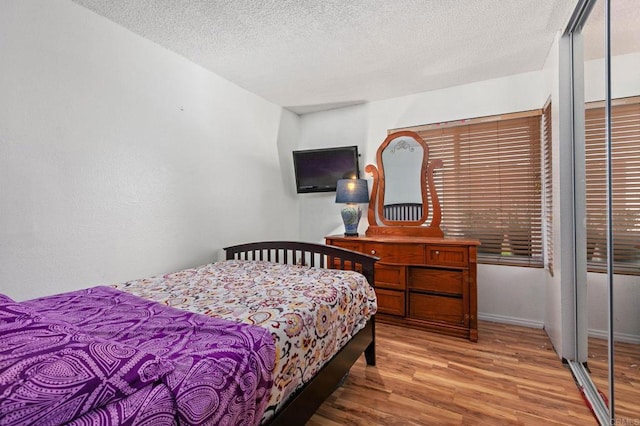 6919 Sandleford Way, San Diego, CA 92139 - bedroom featuring wood finished floors and a textured ceiling