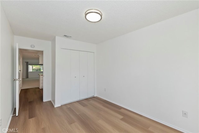 22789 Palm Ave Unit B, Grand Terrace, CA 92313 - unfurnished bedroom featuring wood finished floors, a closet, and baseboards