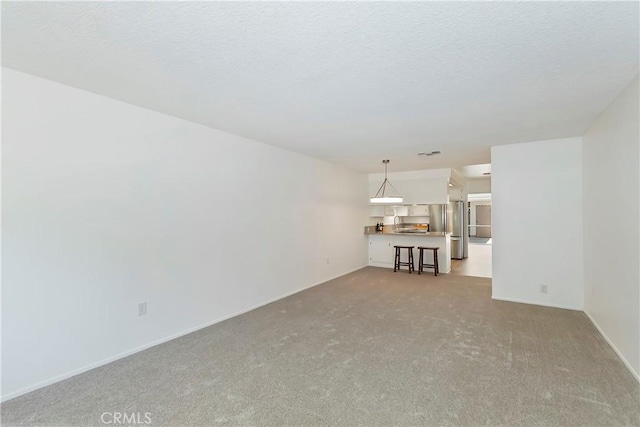 22789 Palm Ave Unit B, Grand Terrace, CA 92313 - unfurnished living room featuring carpet and baseboards