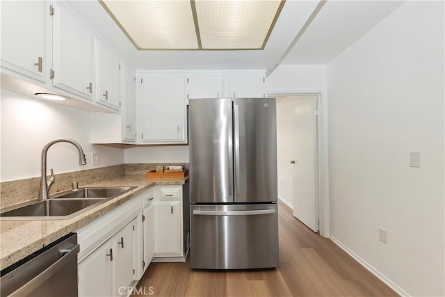 22789 Palm Ave Unit B, Grand Terrace, CA 92313 - kitchen with appliances with stainless steel finishes, a sink, wood finished floors, and white cabinets