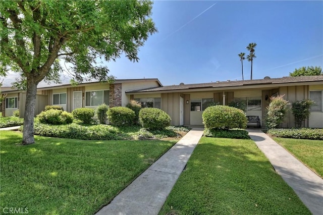 22789 Palm Ave Unit B, Grand Terrace, CA 92313 - ranch-style house with board and batten siding and a front yard