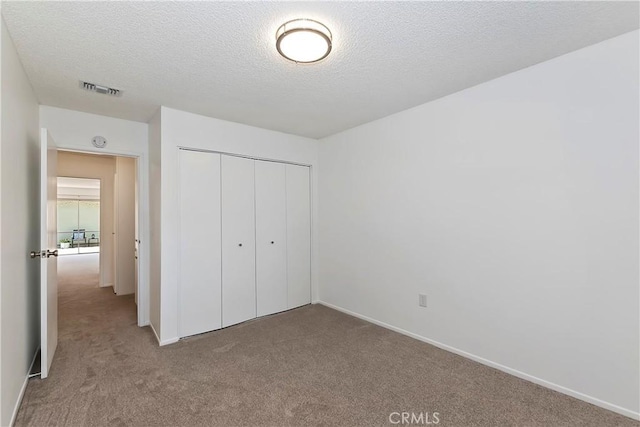 22789 Palm Ave Unit B, Grand Terrace, CA 92313 - unfurnished bedroom with carpet flooring, a closet, a textured ceiling, and baseboards