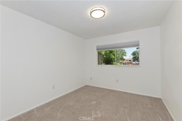 22789 Palm Ave Unit B, Grand Terrace, CA 92313 - spare room with carpet floors, baseboards, and a textured ceiling