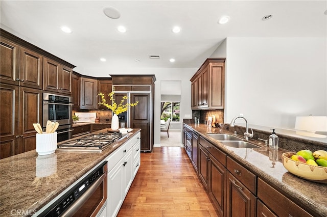3016 Milagro Way, Fullerton, CA 92835 - kitchen featuring a sink, stainless steel gas stovetop, stone counters, light wood-type flooring, and recessed lighting