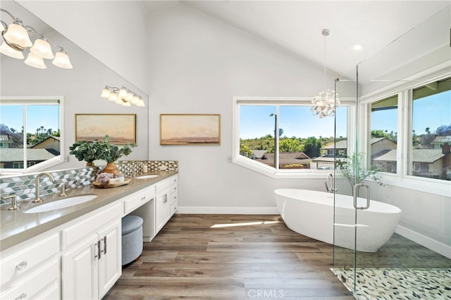 3016 Milagro Way, Fullerton, CA 92835 - bathroom featuring double vanity, a chandelier, healthy amount of natural light, a soaking tub, and high vaulted ceiling