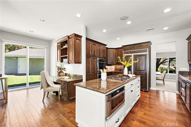 3016 Milagro Way, Fullerton, CA 92835 - kitchen featuring stainless steel gas cooktop, healthy amount of natural light, dark stone countertops, open shelves, and recessed lighting