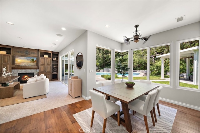 3016 Milagro Way, Fullerton, CA 92835 - dining space with a chandelier, baseboards, hardwood / wood-style floors, a high end fireplace, and recessed lighting