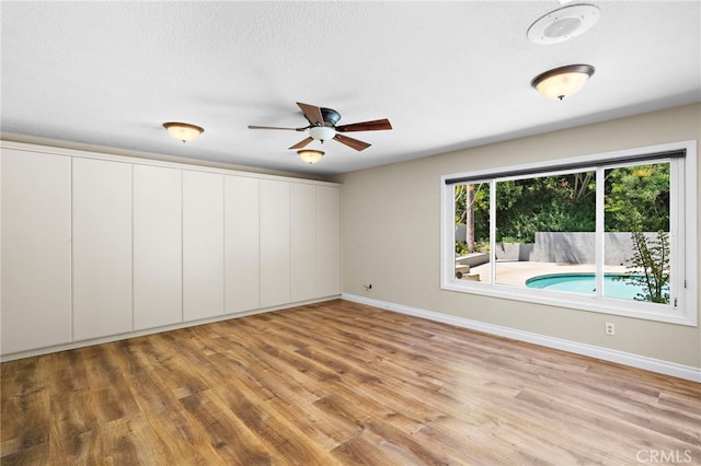 3016 Milagro Way, Fullerton, CA 92835 - unfurnished room with wood finished floors, baseboards, ceiling fan, and a textured ceiling