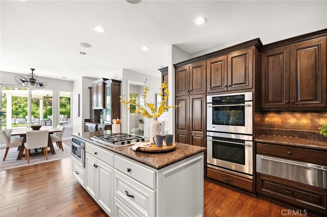 3016 Milagro Way, Fullerton, CA 92835 - kitchen featuring stainless steel appliances, a warming drawer, dark brown cabinetry, white cabinetry, and tasteful backsplash