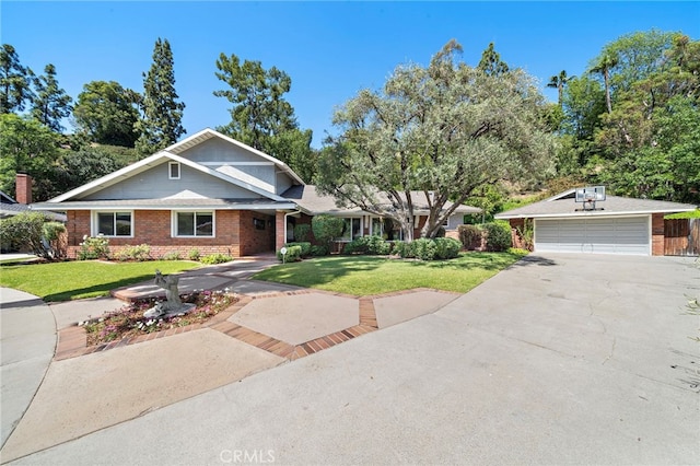 3016 Milagro Way, Fullerton, CA 92835 - view of front of house with a garage, a front yard, brick siding, driveway, and an outbuilding