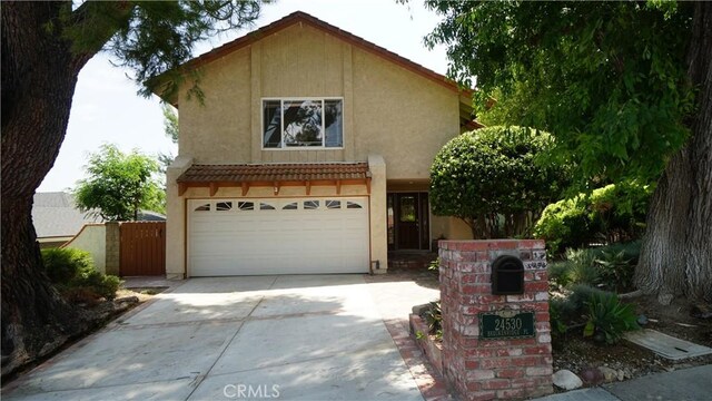 24530 Breckenridge Pl, Newhall, CA 91321 - view of front facade featuring stucco siding, driveway, an attached garage, a tile roof, and a gate