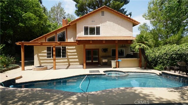 24530 Breckenridge Pl, Newhall, CA 91321 - back of house with stucco siding, a patio, a chimney, french doors, and a fire pit