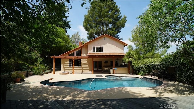 24530 Breckenridge Pl, Newhall, CA 91321 - rear view of house featuring stucco siding, french doors, a chimney, a patio, and a pool with connected hot tub