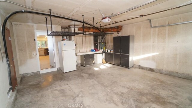 24530 Breckenridge Pl, Newhall, CA 91321 - garage featuring freestanding refrigerator and a garage door opener