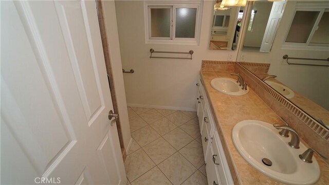 24530 Breckenridge Pl, Newhall, CA 91321 - full bath featuring double vanity, tile patterned flooring, and baseboards