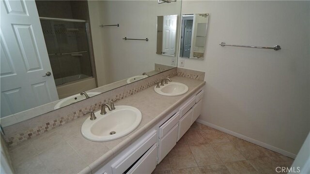 24530 Breckenridge Pl, Newhall, CA 91321 - bathroom featuring double vanity, baseboards, combined bath / shower with glass door, and tile patterned floors
