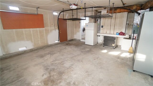 24530 Breckenridge Pl, Newhall, CA 91321 - garage with freestanding refrigerator, a garage door opener, and washer and clothes dryer