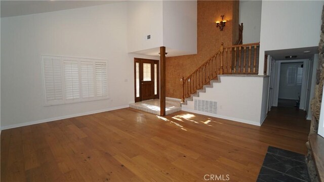 24530 Breckenridge Pl, Newhall, CA 91321 - entrance foyer featuring hardwood / wood-style floors, a towering ceiling, stairway, baseboards, and a chandelier
