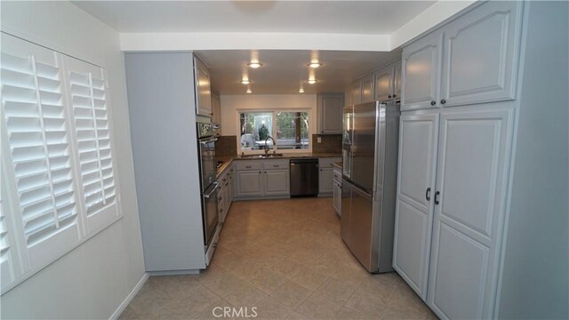 24530 Breckenridge Pl, Newhall, CA 91321 - kitchen featuring stainless steel refrigerator with ice dispenser, black dishwasher, a sink, and baseboards
