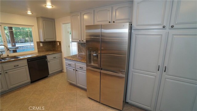 24530 Breckenridge Pl, Newhall, CA 91321 - kitchen with stainless steel refrigerator with ice dispenser, dishwasher, a sink, backsplash, and dark stone counters