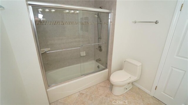 24530 Breckenridge Pl, Newhall, CA 91321 - full bathroom featuring tile patterned flooring, toilet, shower / bath combination with glass door, and baseboards