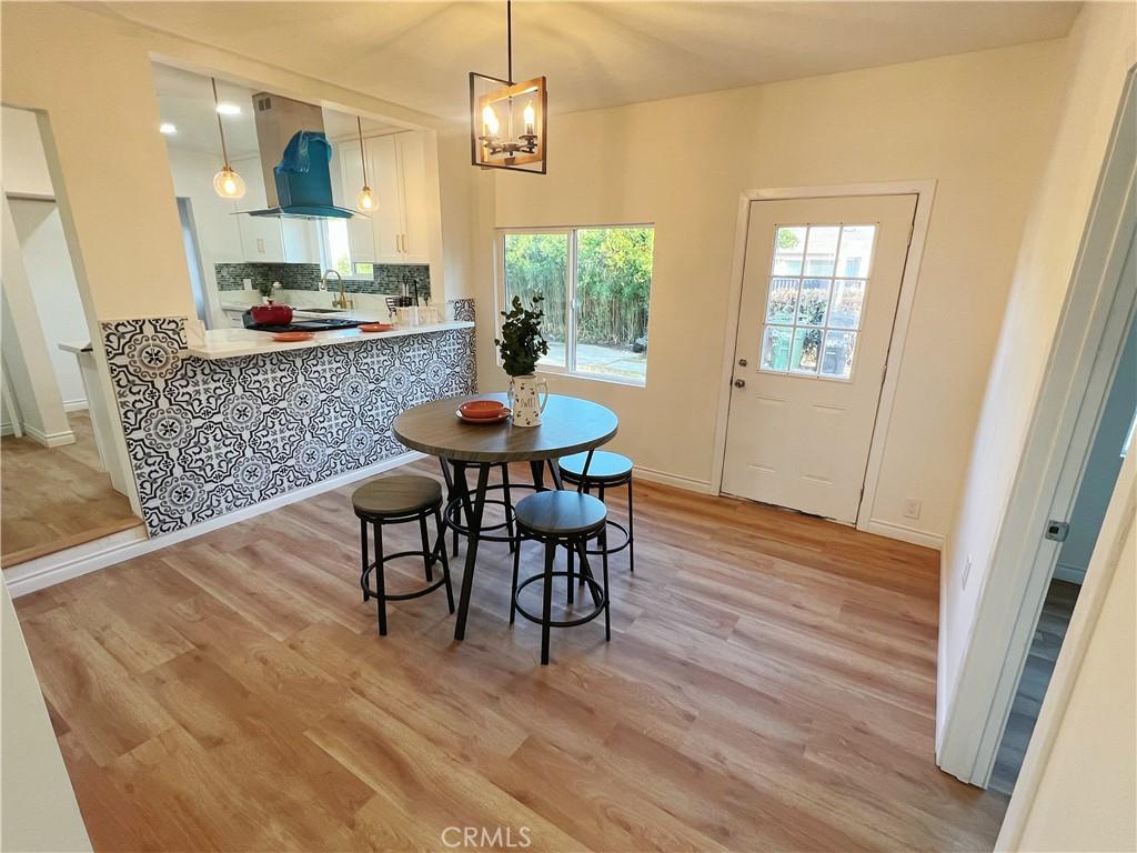 14900 Blackhawk St, Mission Hills San Fernando, CA 91345 - dining room with light wood-style flooring, baseboards, and a chandelier