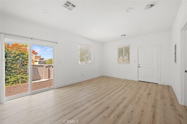 2101 W 76th St, Los Angeles, CA 90047 - spare room with healthy amount of natural light, light wood finished floors, baseboards, and recessed lighting