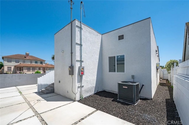 2101 W 76th St, Los Angeles, CA 90047 - back of house with a fenced backyard, a patio, and stucco siding