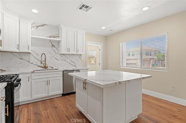 2101 W 76th St, Los Angeles, CA 90047 - kitchen featuring dishwasher, a sink, black range with gas stovetop, open shelves, and backsplash