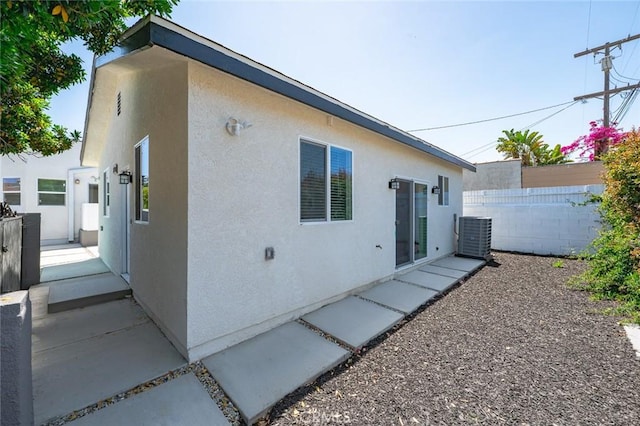 2101 W 76th St, Los Angeles, CA 90047 - back of house featuring stucco siding and central AC unit