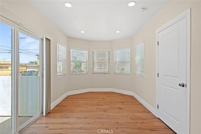 2101 W 76th St, Los Angeles, CA 90047 - empty room featuring light wood finished floors, recessed lighting, baseboards, and a smoke detector