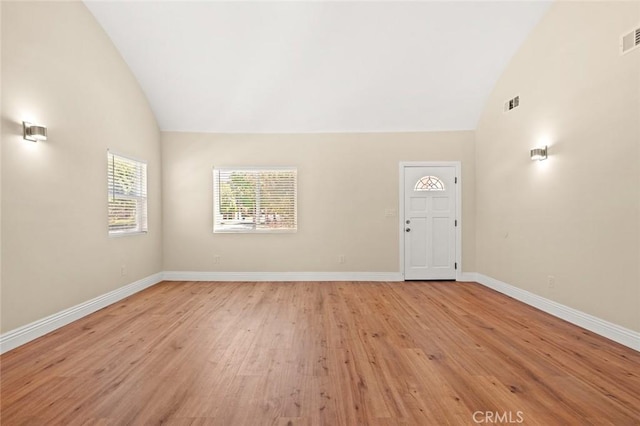 2101 W 76th St, Los Angeles, CA 90047 - empty room featuring light wood-style flooring, baseboards, and high vaulted ceiling