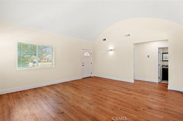 2101 W 76th St, Los Angeles, CA 90047 - empty room featuring vaulted ceiling and light wood finished floors