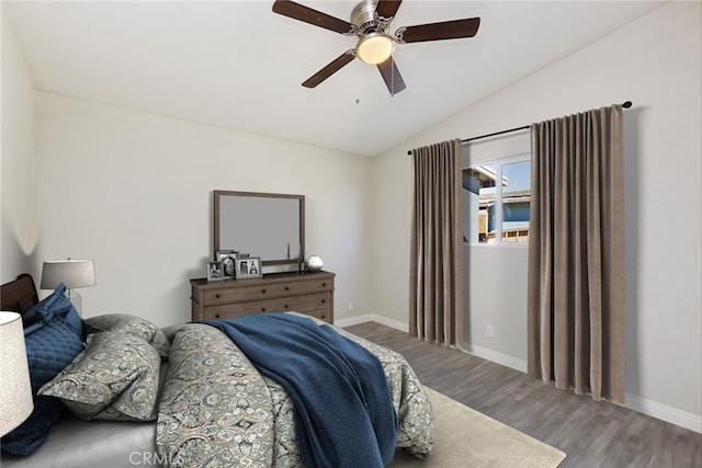 5951 Rose Ellen Ave Unit 29, Palms, CA 92277 - bedroom featuring wood finished floors, vaulted ceiling, baseboards, and a ceiling fan