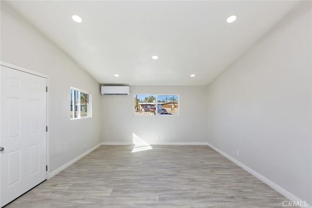 5951 Rose Ellen Ave Unit 29, Palms, CA 92277 - unfurnished room featuring a wall mounted air conditioner, light wood finished floors, baseboards, and recessed lighting