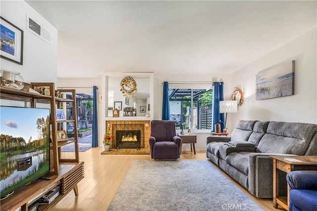 449 Heatherglen Ln, San Dimas, CA 91773 - living room featuring wood finished floors and a brick fireplace