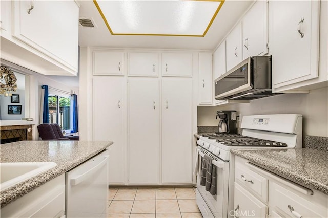 449 Heatherglen Ln, San Dimas, CA 91773 - kitchen with white appliances, light tile patterned floors, white cabinetry, and light stone counters